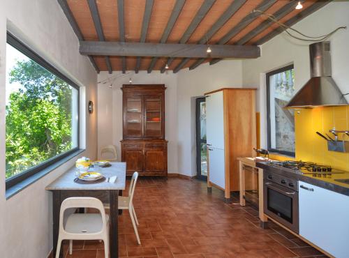 a kitchen with a table and a counter top at Villa Eugenia in Livorno