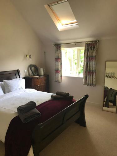 a bedroom with a large bed and a window at The Old Barn 26 Church Street in Market Deeping