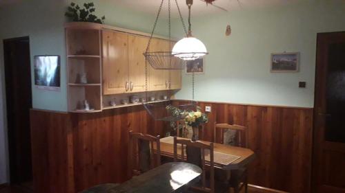 a dining room with a table and chairs and a light at Ladislav in Spišské Vlachy