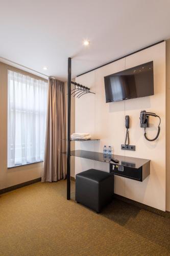 a hotel room with a sink and a window at Cityview Hotel in Amsterdam