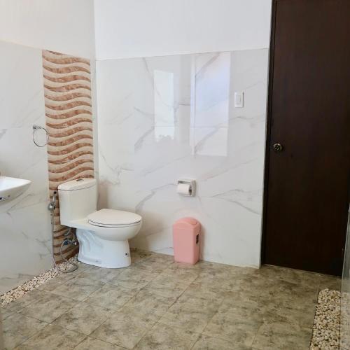 a bathroom with a toilet and a sink at Moon Beach Villas El Nido in El Nido