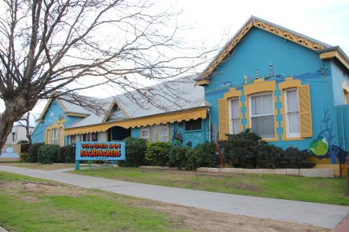 a blue house with a sign in front of it at Wander Inn Bunbury in Bunbury