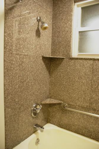 a bathroom with a sink and a shower at The Mosser Hotel in San Francisco