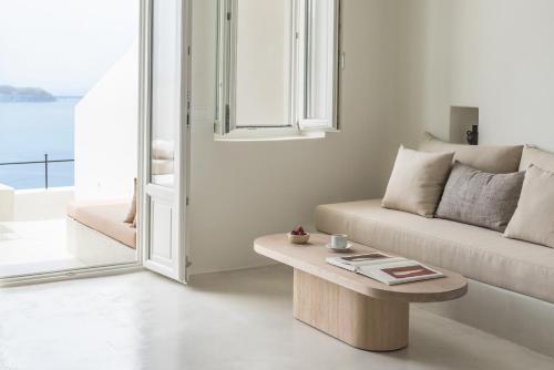 a living room with a couch and a coffee table at Enigma Suites in Fira