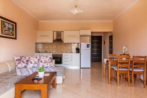 a living room with a couch and a table at Great Alexander Suites in Sarandë