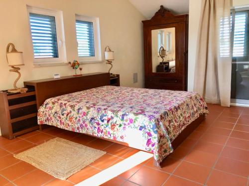 a bedroom with a bed and a dresser and a mirror at Casa na Comporta in Comporta