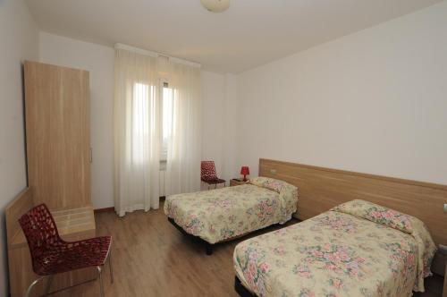 Łóżko lub łóżka w pokoju w obiekcie Residence Piemonte