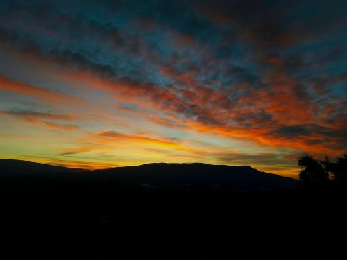 a sunset with a mountain in the background at Cortijo Los Maximos in Turón