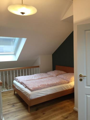 a bedroom with a bed in a attic at Ferienwohnung Kamp "Blick ins Grüne" in Potsdam
