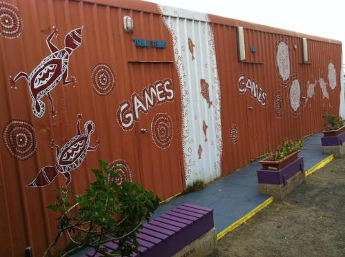 a fence with graffiti on the side of it at Dolphin Retreat Bunbury in Bunbury
