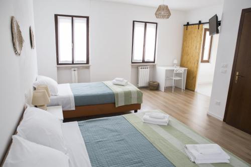 a bedroom with two beds and a living room at Albergo Mio Boutique Hotel - Adults Only in Lazise