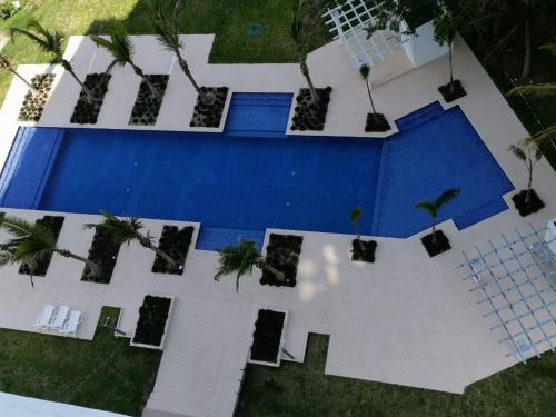 an overhead view of a swimming pool with palm trees at Ocean 3, Playa Blanca in Río Hato