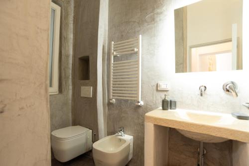 a bathroom with a toilet and a sink and a mirror at A casa di Dany in Polignano a Mare