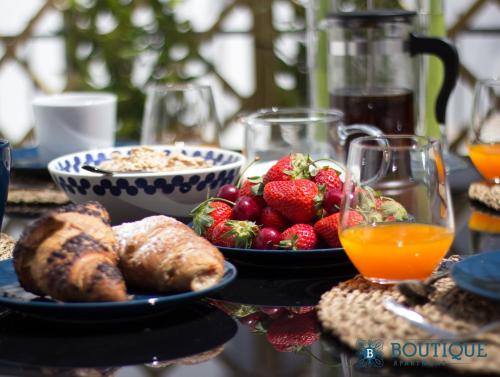 a table topped with plates of food and fruit at Boutique Apartment Eleganza in Chiusi