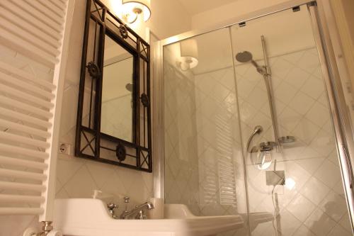 a bathroom with a shower and a sink and a mirror at Torre del Falco in Spoleto