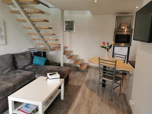 a living room with a couch and a table at Gite d' angel in Kermaria-Sulard