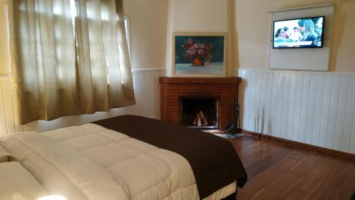 Una cama o camas en una habitación de Refúgio das Rosas