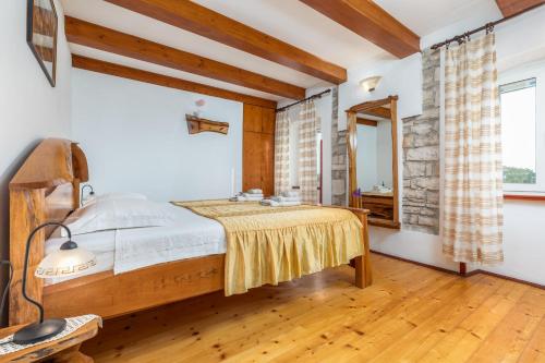 a bedroom with a bed and a mirror at Holiday Home Ana in Kanfanar