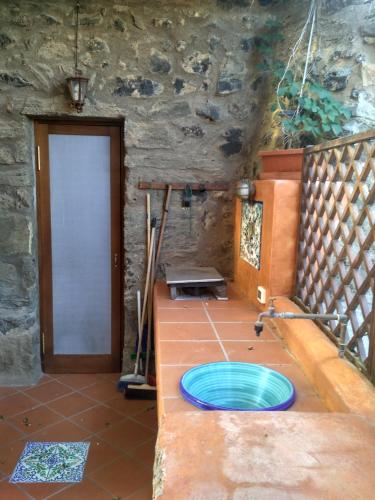 a bathroom with a blue frisbee on the floor at i dammusi di Egle in Pantelleria