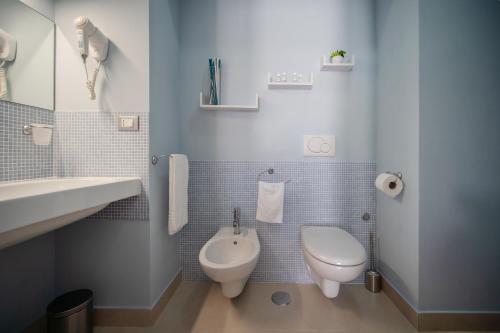 a blue tiled bathroom with a toilet and a sink at B&B PROCHYTEA in Procida