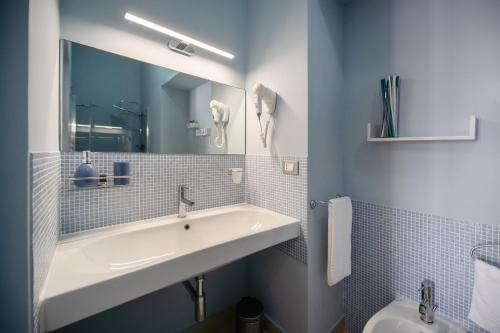 a bathroom with a sink and a mirror and a toilet at B&B PROCHYTEA in Procida
