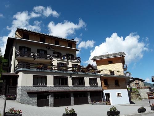 a building with balconies on the side of it at Hotel Meublè Adler - Rooms & Mountain Apartments in Santa Caterina Valfurva