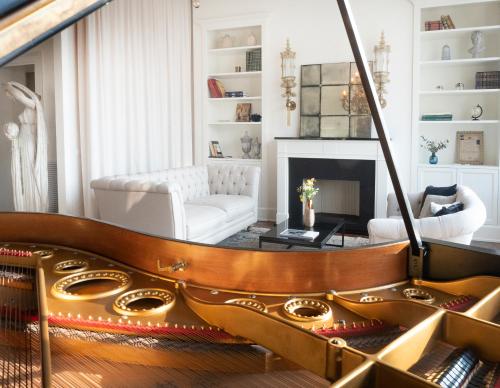 a living room with a piano and a fireplace at Palazzetto Foscari in Venice