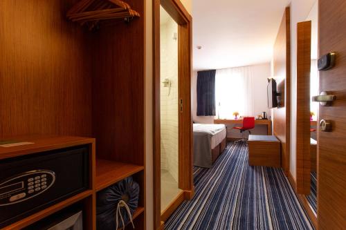 a hotel room with a bed and a mirror at Best Western Terminus Hotel in Sofia