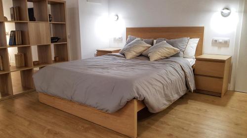 a bedroom with a large bed with two night stands at Loft Yolanda Centro in Cuenca