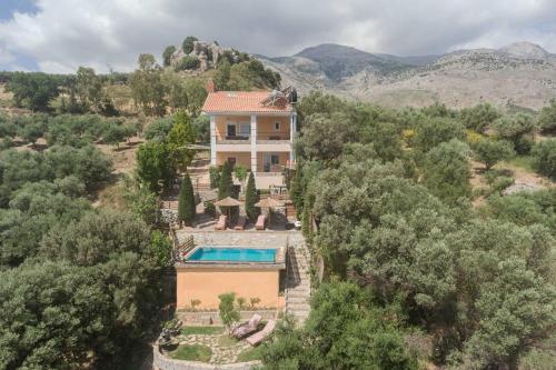 an aerial view of a house with a swimming pool at Villa Kastelas in Kato Asites