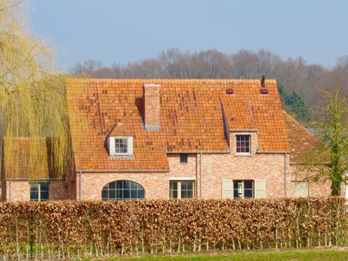 a large brick house with an orange roof at LA BELLE IDEE in Nokere