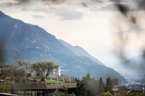 a view of a mountain with a town and a city at SPA & Relax Hotel Erika in Tirolo
