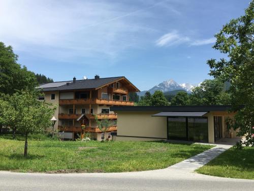 a house with a mountain in the background at Häringer Mühle in Bad Häring