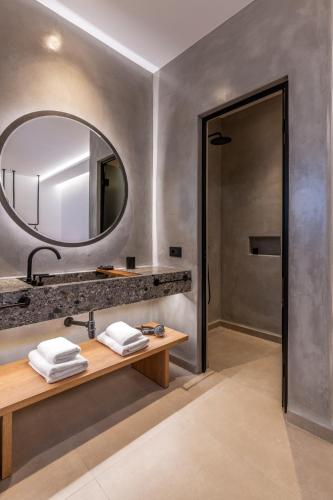 a bathroom with a sink and a mirror at Avra Mykonos in Tourlos