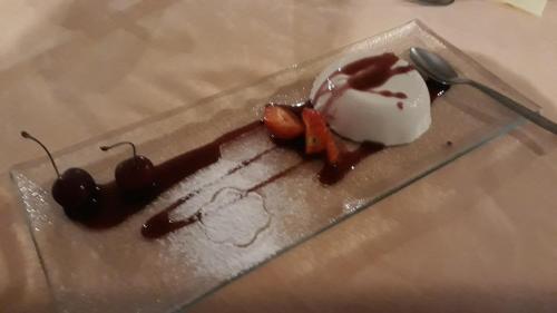a dessert with ice cream and cherries on a plate at Hotel San Marino in Laglio