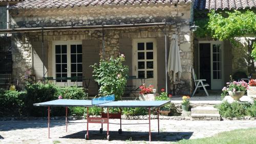 a ping pong table in front of a house at Mas Grimaud - Gîte- Studio et chambres d'hôtes familiales in Eygalières