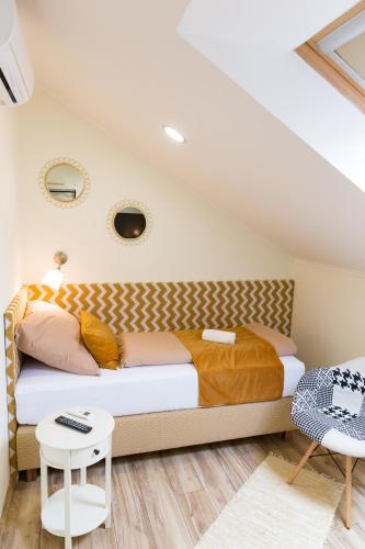 a bedroom with a bed and a table at SoleGutta in Kolárovo