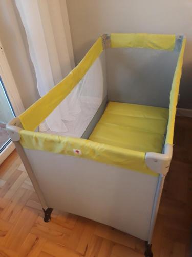 a bed with a yellow canopy in a room at Apartament Pod Lasem in Gdańsk