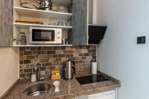 a small kitchen with a sink and a microwave at Element Garden in Istanbul