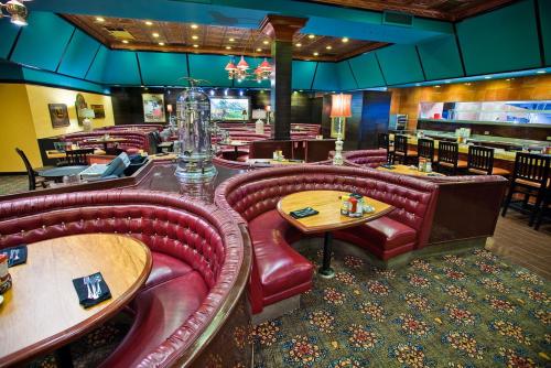 a restaurant with red leather chairs and tables at Carson Valley Motor Lodge and Suites in Minden