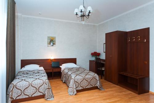 BogorodskにあるPark Hotel Bogorodskのベッド2台とデスクが備わるホテルルームです。