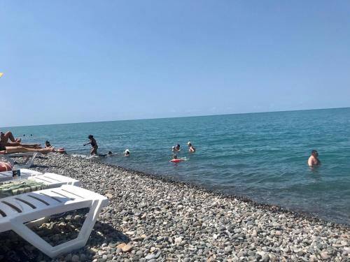 a group of people in the water at the beach at Sweet Home at Ninoshvili 3 in Batumi