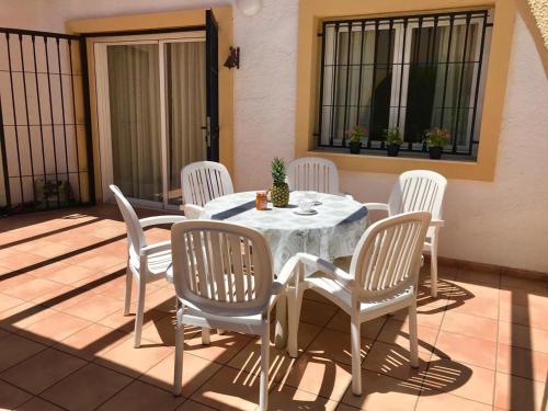a white table and chairs on a patio at Casa de familia in Calpe