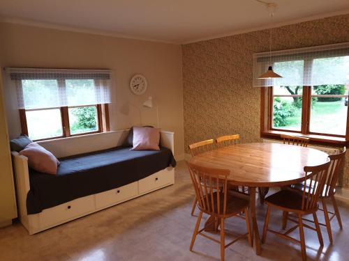 a living room with a couch and a dining room table at WESTERQVARN in Mölntorp