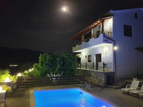a villa with a swimming pool at night at Vila Palma in Berat