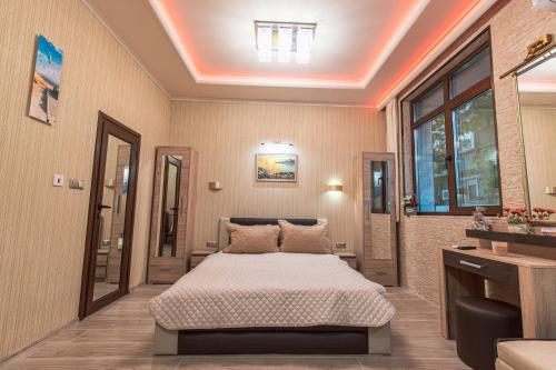 a bedroom with a bed in a room at Deluxe Studios City Center in Burgas City