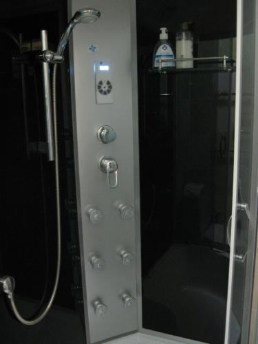a shower with a glass door in a bathroom at Private Apartment in Tallin (Pelguranna) in Tallinn