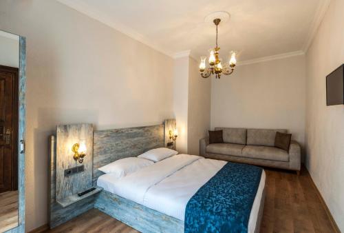 a bedroom with a large bed and a couch at Element Garden in Istanbul