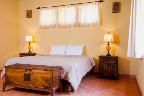 a bedroom with a bed and two lamps on tables at Cerritos Surf Town - Beach Front Property in El Pescadero