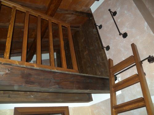 an attic with a wooden ceiling and a ladder at La Giada in Tivoli